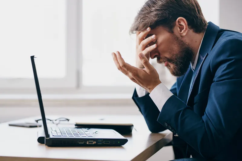 Frustrated employee at computer